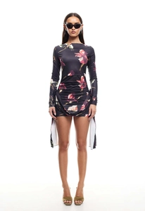 Detail of floral printed mini dress showing side ruched drawstring and long ribbon ties