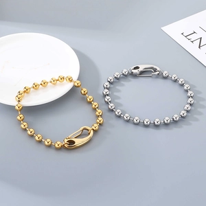 Close-up of 6mm gold and silver bead chain bracelets with large lobster clasps