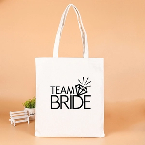 Detailed view of white canvas tote bag with black Team Bride print and diamond motif