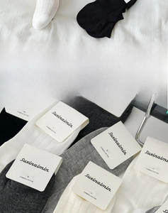 Detailed view of breathable combed cotton socks with ribbing and quality labels
