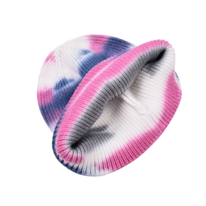 Detailed close-up of the tie-dye ribbed knit texture and pink-blue gradient on the beanie