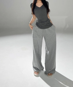 Detail of grey V-neck short sleeve T-shirt and matching drawstring lounge pants on model