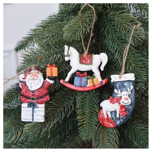 Vintage Christmas ornaments including Santa and reindeer on tree branches with rustic ropes