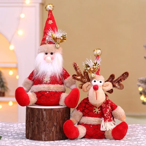 Detail of plush Santa and Reindeer sitting on a wood stump with cozy fireplace background