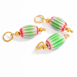 Three colorful striped glass charms with gold metal rings on a white background