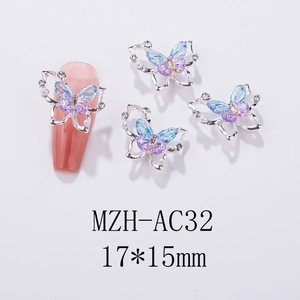Macro view of 3D aurora butterfly nail charms with pearls and laser rhinestones
