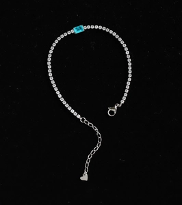 Detail of blue zircon bracelet with heart pendant and adjustable silver chain