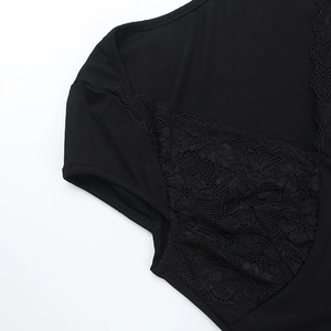Detailed close-up showing black lace stitching and knit texture on the crop top sleeve