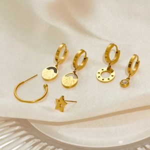 Detailed view of six-piece gold plated stainless steel earring set with celestial star motifs