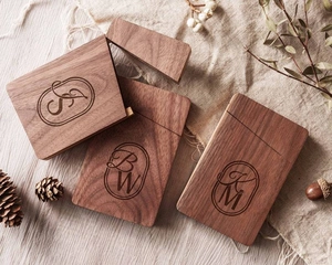 Detailed view of personalized walnut wood business card cases with custom engravings