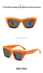 Detail view of orange cat-eye sunglasses with dark grey lenses and gold metal accents
