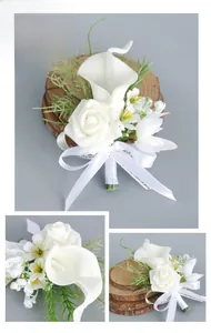 Macro detail of white PU calla lily and rose boutonniere with elegant silk ribbon