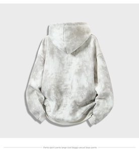 Detail of gray tie-dye oversized hoodie showing back view and foggy cloud texture