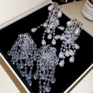 Elegant silver tassel earrings with crystals and pearls displayed in a black jewelry box