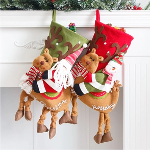 Detail of Christmas stockings with reindeer, Santa and snowman on a white fireplace