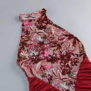 Close-up of red floral sequin embroidery on halter neck mesh and pleated dress detail