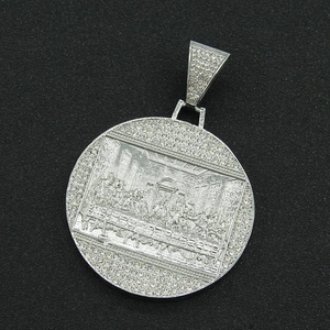 Macro detail of silver hip hop pendant featuring Last Supper relief with sparkling crystals