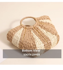 Detail view of the flat woven bottom and bicolor stripes of the straw beach tote bag