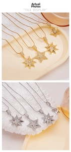 Close-up of gold and silver snake chain necklaces with zircon star starburst pendants