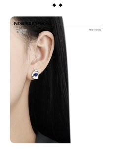 Detail view of S925 silver oval stud earring with deep blue lapis lazuli on ear