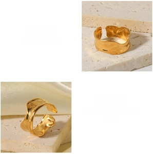 Detailed close-up of gold open ring featuring irregular hammered tin foil texture