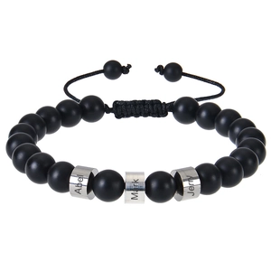 Close-up of personalized matte black beaded bracelet with custom engraved steel beads