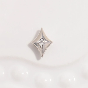 Close-up of S925 sterling silver four-point star bead with a small white zircon stone