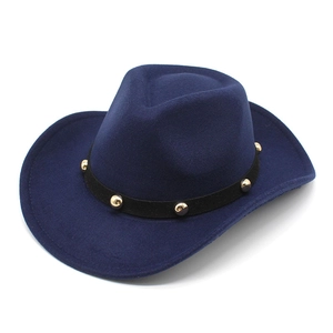 Deep blue wool felt cowboy hat with black leather band and gold stud rivets on white background