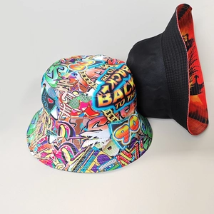 Detail view of double-sided reversible bucket hat showing retro graffiti and solid black style