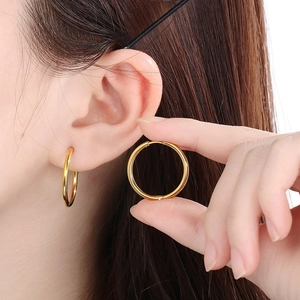 Classic 18K gold-plated stainless steel hoop earrings worn by a model for a minimalist look