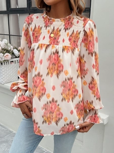 Detail of floral print blouse with pleated high neck and smocked bodice design