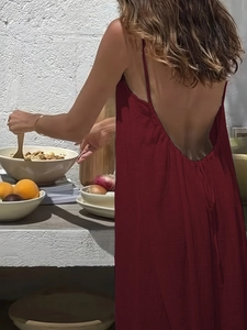 Detail of the backless wine red dress showing slim straps and deep V-back design