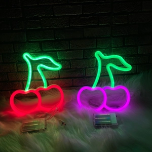Red and purple LED cherry neon lights on white rug with USB and battery power options