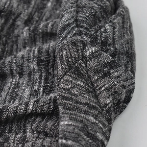 Close-up of heather grey knitted headband showing soft ribbed texture and cross-knot detail
