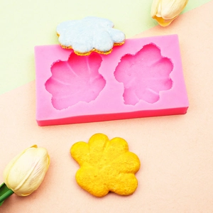 Detailed pink silicone flower mold with blue and yellow floral resin casting results