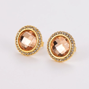 Macro detail of gold round stud earrings with champagne glass stone and pavé crystal halo