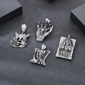 Detail of gothic silver pendants featuring skull, demon claw, and death reaper motifs