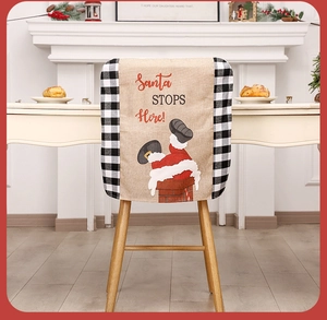 Christmas chair cover with Santa chimney design on dining chair in cozy home setting
