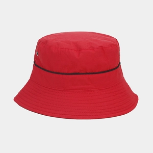 Detail showing red waterproof bucket hat with black trim and durable texture