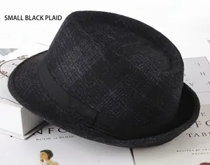 Détail d'un chapeau fedora à carreaux noirs présenté sur des livres anciens