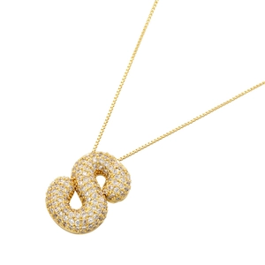 Macro shot of 18K gold plated S-letter pendant with sparkling pavé zircon stones