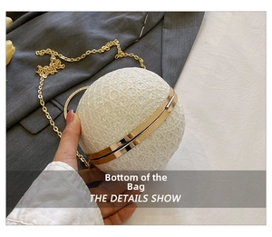 Detail of white sequin lace spherical evening bag with golden metal ring handle