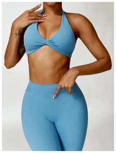 Detail of light blue cross-knot sports bra and high-waisted seamless leggings set