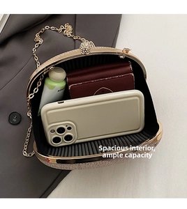 Interior view of gold evening clutch showing capacity for smartphone and essentials