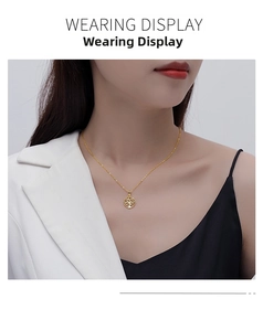 Wearing display of the golden hollow Tree of Life pendant necklace on a model