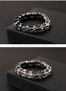Detailed view of vintage silver dragon scale chain bracelet with punk gothic metal texture