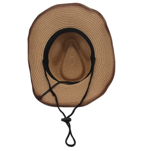 Detail of a western straw cowboy hat featuring an adjustable chin strap and sweatband