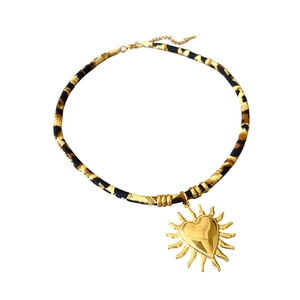 Vintage leopard print fabric cord necklace with a golden sun heart pendant charm