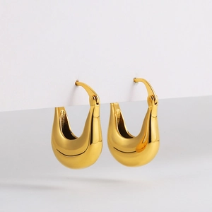 Detailed view of chunky 18K gold plated teardrop hoop earrings with a mirror finish
