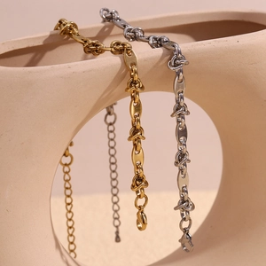 Minimalist 14K gold and silver stainless steel coffee bean link anklets on ceramic art